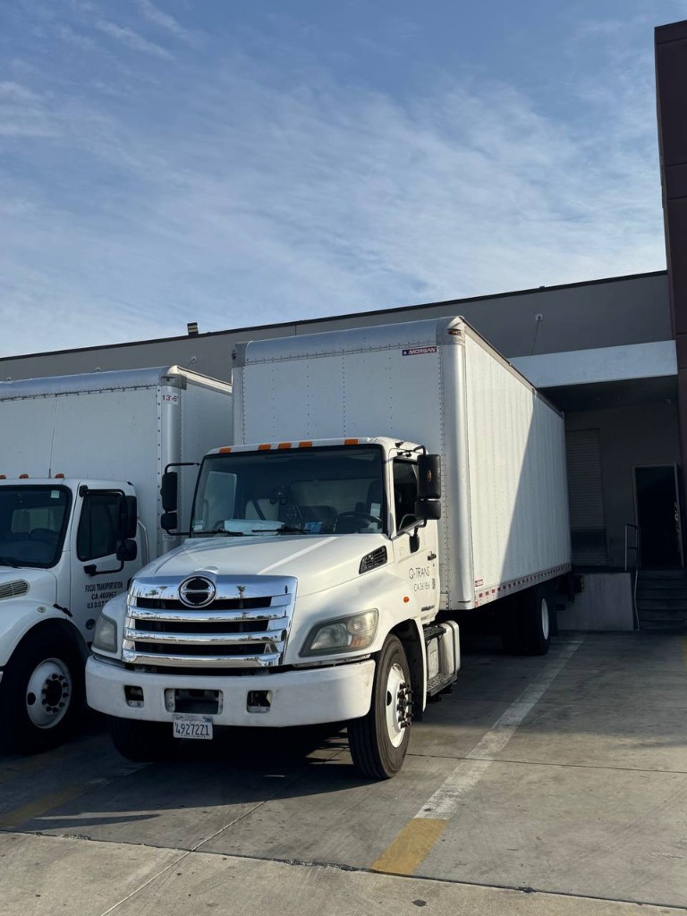 Clean commercial moving trucks at a professional facility